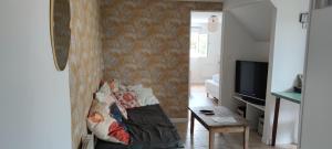 a living room with a couch and a table at Appartement Saint Sulpice la Pointe in Saint-Sulpice