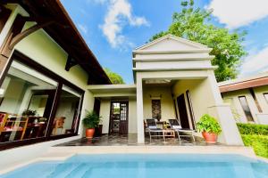 a house with a swimming pool in front of it at Luang Prabang View Hotel in Luang Prabang