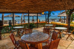 an outdoor patio with tables and chairs and the ocean at Pousada Jagatá in Tutóia +32 photos