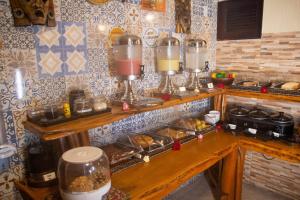 a kitchen with a counter with some food on it at Pousada Jagatá in Tutóia