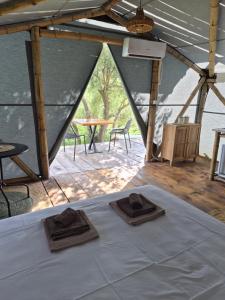 a tent with two hats on top of a bed at Bamboo glamping in Kotor