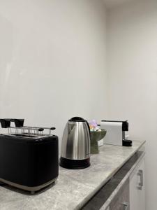 a kitchen counter with a toaster and a coffee pot at Casa Carolina Cinisi in Cinisi