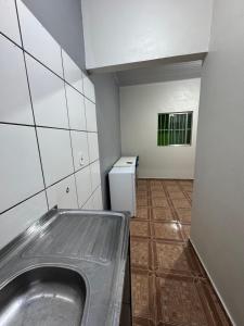 a bathroom with a metal sink in a room at Pousada e Hostel das Rosas in Barreirinhas +36 photos