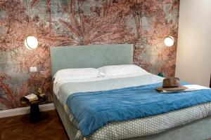 a bedroom with a bed with a hat on it at Gloeden House in Taormina