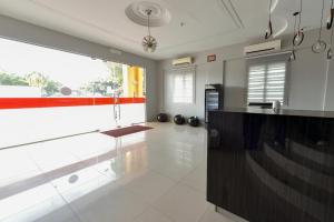 a kitchen with a counter and a large window at SMC Hotel Alam Avenue in Shah Alam