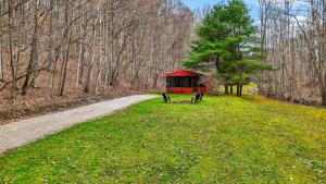 a smallshed in the middle of a field next to a road at Creekside Hideaway in Laurelville