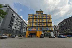 a yellow building in the middle of a parking lot at SMC Hotel Alam Avenue in Shah Alam