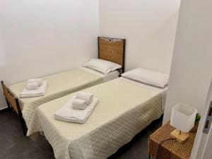 two beds in a room with towels on them at Casa Carolina Cinisi in Cinisi +33 photos