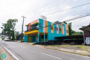 a colorful building on the side of a street at INSTAY Hotel Dieng Chill Serenity in Garung