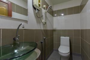 a bathroom with a glass sink and a toilet at SMC Hotel Alam Avenue in Shah Alam +38 photos