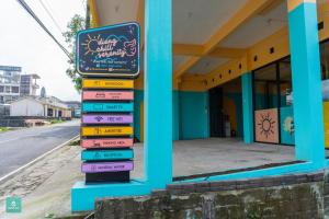 a stack of books on the side of a building at INSTAY Hotel Dieng Chill Serenity in Garung