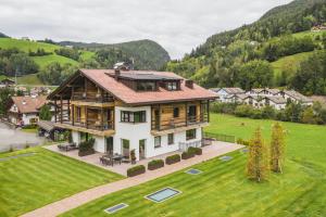 an aerial view of a house in a green field at Chalet Bel Plan in Ortisei