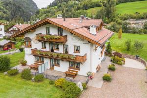 a large white house with flowers on the balcony at Chalet Bel Plan in Ortisei