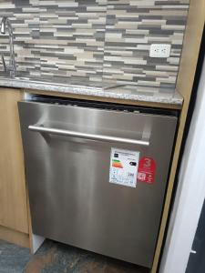 a stainless steel refrigerator in a kitchen with a counter at Casa en Sur de Quito in Quito