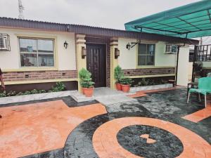a house with a patio with a fire place at Summer Breeze Guest House in Suru Lere