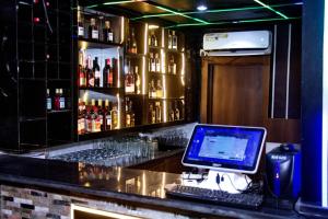 a bar with a laptop computer sitting on a counter at Summer Breeze Guest House in Suru Lere