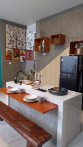 a kitchen with a counter with plates on it at The Yoora Villa in Ngadipuro
