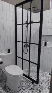 a bathroom with a shower with a toilet in it at The Yoora Villa in Ngadipuro +4 photos