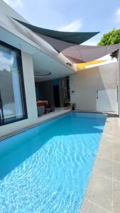a swimming pool in the middle of a house at The Yoora Villa in Ngadipuro