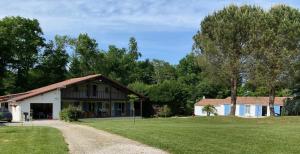 a house with a gravel road in front of it at Gîte des Petites Fadettes "MELUSINE" in Lannepax