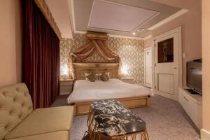 a bedroom with a bed and a couch and a television at Hotel Pharaoh-Adult Only in Sapporo