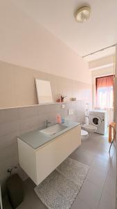 a white bathroom with a sink and a toilet at La casa al mare in Grottammare +3 photos