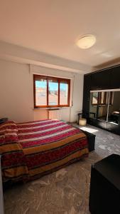 a bedroom with a large bed with a colorful blanket at La casa al mare in Grottammare