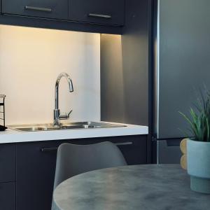 a kitchen with a sink and a table at Stelios Studios Sougia in Sougia