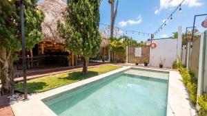 a swimming pool in the backyard of a house at Hotel y Beach Club Casa Mia Xulha -Bacalar in Xul-Ha