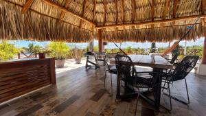a restaurant with a table and chairs and a view at Hotel y Beach Club Casa Mia Xulha -Bacalar in Xul-Ha