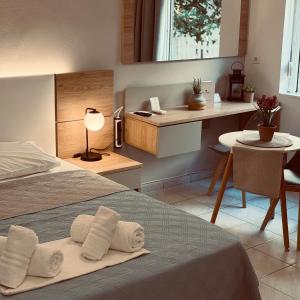 a bedroom with a bed with towels on it at Stelios Studios Sougia in Sougia