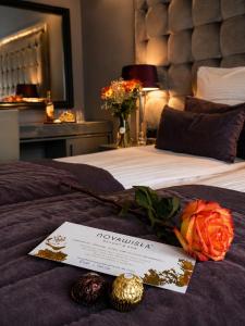 a hotel room with a sign on a bed at NovaWisła Resort & SPA in Wisła