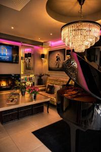 a living room with a couch and a piano at NovaWisła Resort & SPA in Wisła