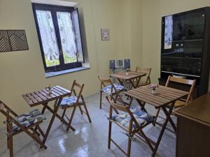 a room with tables and chairs and a flat screen tv at Domus Anemone B&B in Avellino