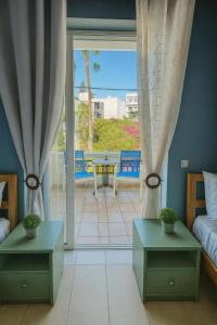 a bedroom with a bed and a patio with a table at Rethymno Blue Residence in Rethymno