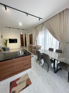 a kitchen and living room with a table and chairs at AL Rabie Resort ,Nizwa Grand Mall in Firq