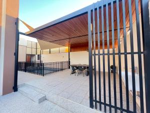 a fence in front of a patio with a table at AL Rabie Resort ,Nizwa Grand Mall in Firq