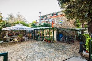 a patio with tables and chairs and an umbrella at Rooms Barbieri Rovinj in Rovinj
