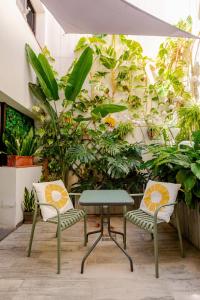 two chairs and a table in front of plants at Beach LOFT Tabaiba in Tabaiba