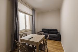 a living room with a table and chairs and a couch at HARBOR BREEZE Trapani in Trapani