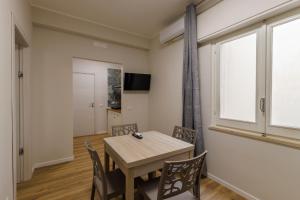 a dining room with a table and chairs and a window at HARBOR BREEZE Trapani in Trapani +28 photos