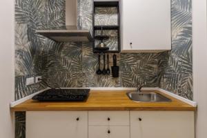 a kitchen with a sink and a counter top at HARBOR BREEZE Trapani in Trapani