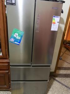 a stainless steel refrigerator with a sign on it at Tinejdad Auberge in Tinejdad