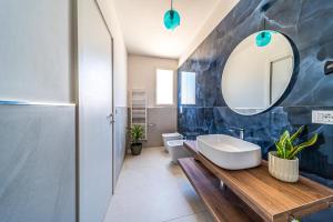 a bathroom with a sink and a mirror at Murieri Rooms in Otranto +80 photos