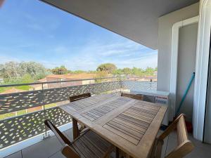 a table and chairs on a balcony with a view at A 150m de la plage - Coquet appartement pour 4 personnes in Vias