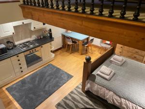 an overhead view of a kitchen with a bed and a table at Tredrea Annexe - Self Contained Cornish hideaway in Truro