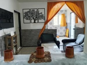 a living room with two chairs and a table at Cabanon plage david in Bouznika