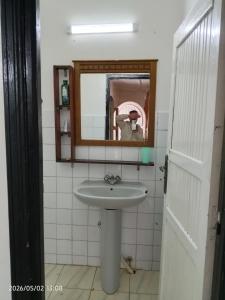 a bathroom with a sink and a mirror at Cabanon plage david in Bouznika +30 photos
