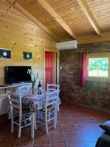 a dining room with a table and chairs in a cabin at Apartma Suzy in Pobegi