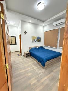 a bedroom with a blue bed in a room at Dar AL-HANAA in Nouakchott +6 photos